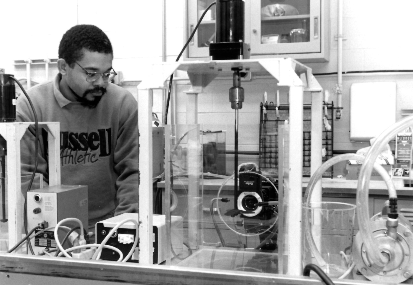 Grad student Joel Ducoste adjusts camera settings in a study of flocculation, 1996